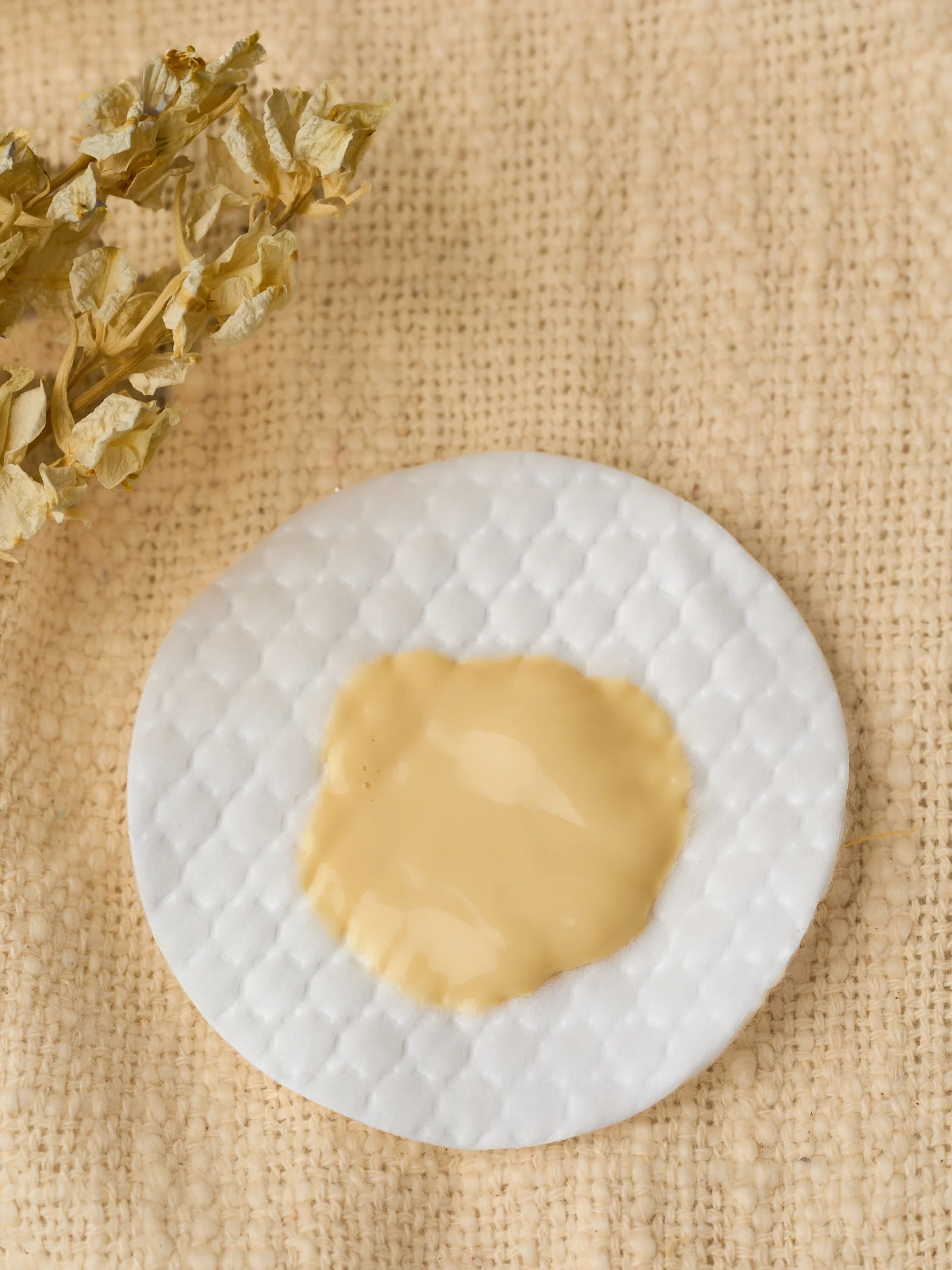 The pale yellow Neloura formula on a real pad.
